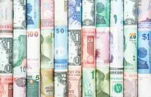 Rolls of money from various countries around the world