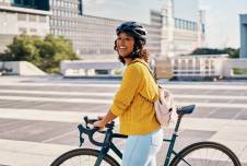 Woman smiling on a bike in the city