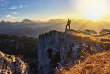 Person looking over landscape of mountains.