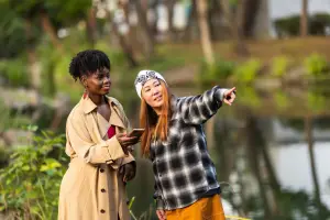 Someone pointing and giving someone else directions outdoors