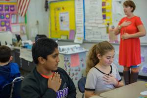 a picture of a young boy and a girl enjoying yoga in their calss