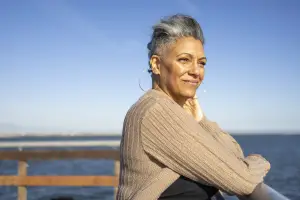 Woman standing on a pier looking out over the water